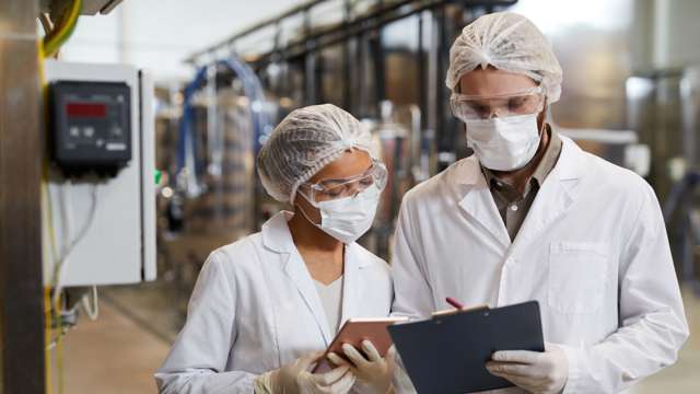 Woman and man inspect facilities